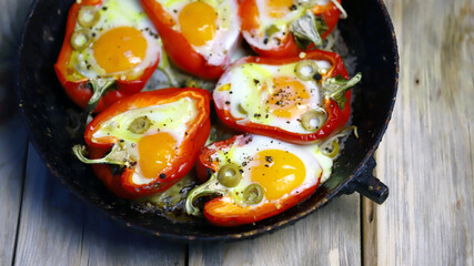 Selective focus. Red peppers with egg, baked in a pan. Healthy food. Autumn lunch.