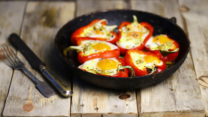 Selective focus. Red peppers with egg, baked in a pan. Healthy food. Autumn lunch.