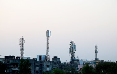 Four telecommunication tower on top of building terrace