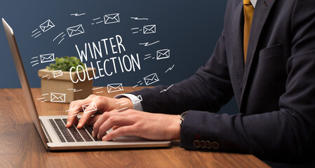Businessman working on laptop with WINTER COLLECTION inscription, online shopping concept