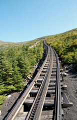 Fototapeta na wymiar Cog railway track disappearing into the distance over the top of Mount Washington
