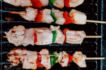 Selective focus. Raw skewer of chicken with pieces of red and green peppers, pork rib in a barbecue. Food. Life Style.