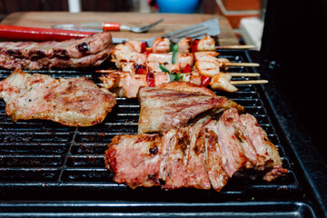 Selective focus. Skewer of chicken with pieces of red and green peppers, pork rib in a barbecue. Food. Life Style.