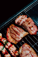 Selective focus. Skewer of chicken with pieces of red and green peppers, pork rib in a barbecue. Food. Life Style.