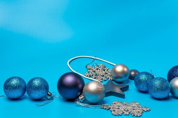Christmas multicolored balls and snowflakes on a blue background.