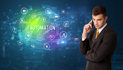 Businessman thinking in front of technology related icons and AUTOMATION inscription, modern technology concept