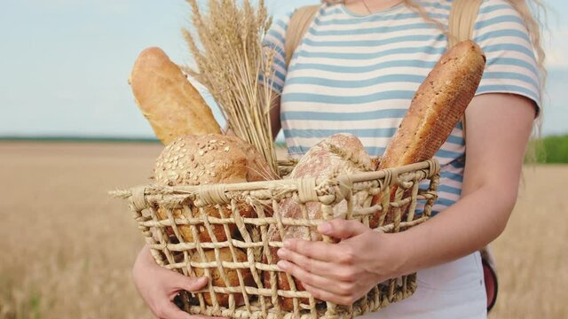 Agriculture farmer concept details of a box with fresh bread lady holding in the middle of wheat field