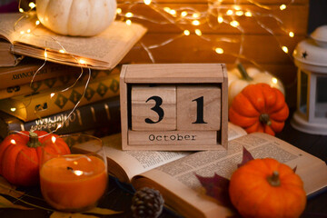 cozy autumn halloween evening. books, pumpkins, leaves, garland