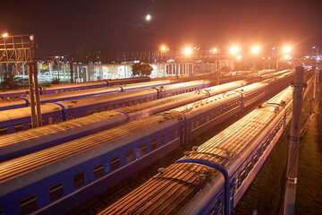 Fototapeta na wymiar Brest, Belarus - October 22, 2020 - Several trains wait for departure at the station at night. Train sorting point