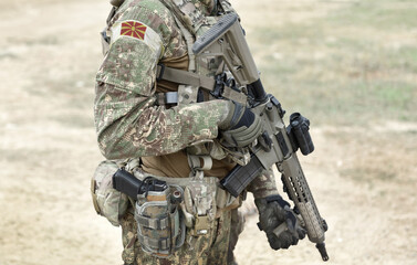 Fototapeta premium Soldier with assault rifle and flag of North Macedonia on military uniform. Collage.