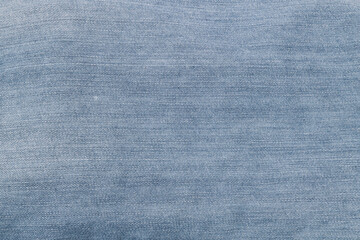 Fototapeta na wymiar Textured background of blue denim jeans with seam and thread stitch. 