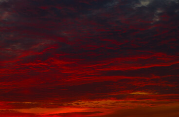 Red clouds in the sunset sky (background) - 387615217