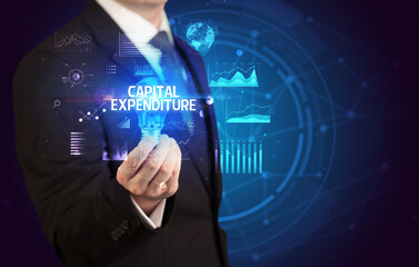Businessman holding lightbulb with CAPITAL EXPENDITURE inscription, Business idea concept