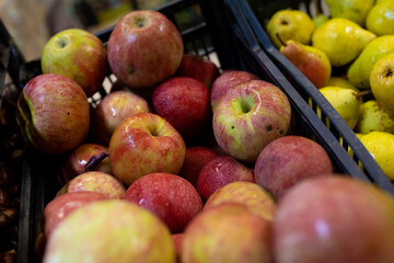At the greengrocer, apples in the basket. Seasonable fruit at the market. Close up shot