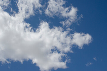 Obraz premium White clouds on a blue sky. Background.