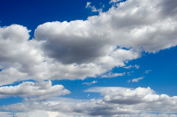 Obraz premium White clouds on a blue sky. Background.