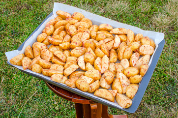 Raw chopped potatoes on a baking sheet.