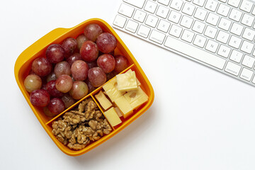 Food in Plastic containers ready to eat with Cheese, grapes and nuts