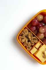 Food in Plastic containers ready to eat with Cheese, grapes and nuts