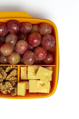 Food in Plastic containers ready to eat with Cheese, grapes and nuts