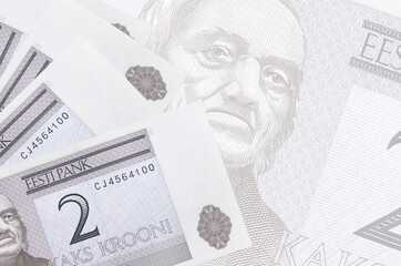 2 Estonian kroon bills lies in stack on background of big semi-transparent banknote. Abstract...