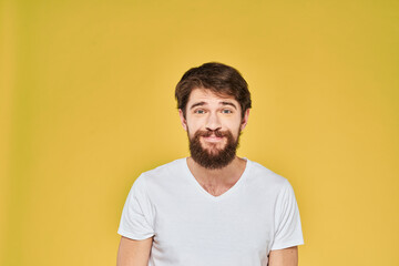 Fototapeta premium Bearded man white t-shirt emotions gestures with hands fun yellow background