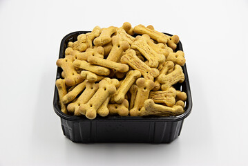 72 -  Dog biscuit in the form of bones in  a black plastic box