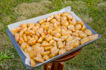 Raw chopped potatoes on a baking sheet.