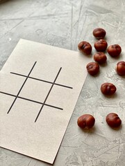 Step by step, children's creativity, game TIC TAC toe of chestnuts.