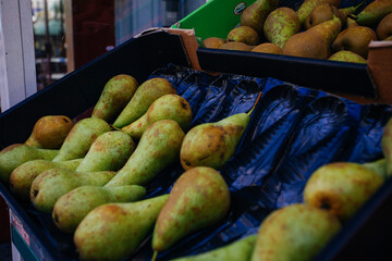 resh organic yellow pear stand out among many large background pears in the market. Fruit of yellow...