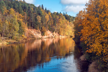 Landscape view of red sandstone caves on Gauja river in Sigulda, Latvia on a autumn day