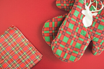 Red kitchen checkered Christmas gloves. Christmas oven protective mitt. New Year and Christmas concept.