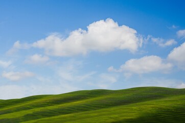 Beautiful landscape hill with blue sky in Tuscany, Famouse town for spring field, Italy.