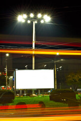 Blank signboard on the background of the night city. Mockup for design. Free space for advertising....