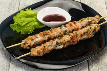 Minced pork skewer kebab with sauce