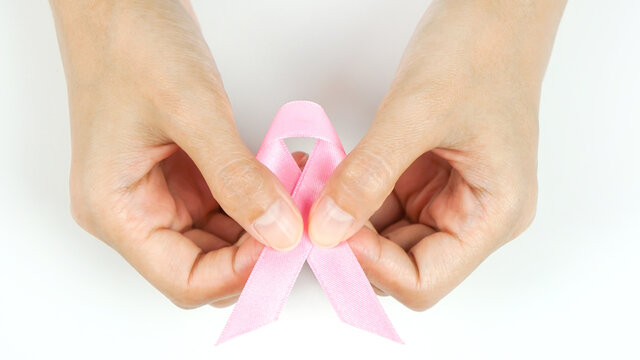 A woman holding a ribbon to educate about pink cancer,healthcare and medicine concept .