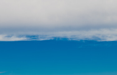 two halves: white clouds and blue sky