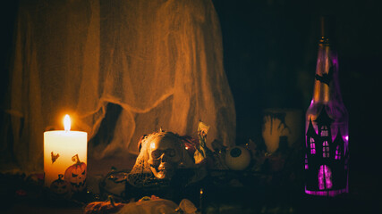 Halloween decorations with skeleton, bottle and candle