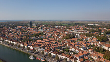 Fototapeta na wymiar Above the red roofs of Zierikzee in the south of Holland. Quiet beautiful evening light. 