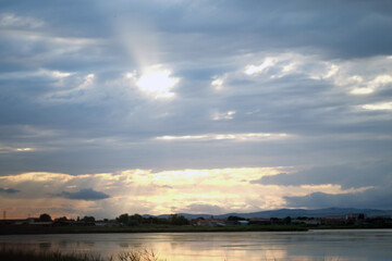 the salty lake Pomorie. a swarm of sea gulls is sitting on a multiple wooden polls stucked into a salt water pond used for salt extraction