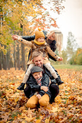 Family make people pyramid. leaf fall, lifestyle. Autumn season.