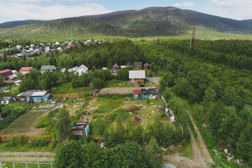 Fototapeta na wymiar Aerial Townscape of Suburban Village Sosnoviy Bor located in Northwestern Russia on the Kola Peninsula near the town Kandalaksha