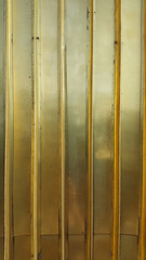 Golden metal. Golden panel. Wall of steel panels golden color