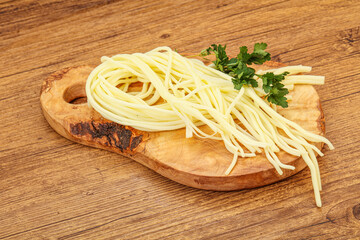 Chechil spaghetti cheese over board