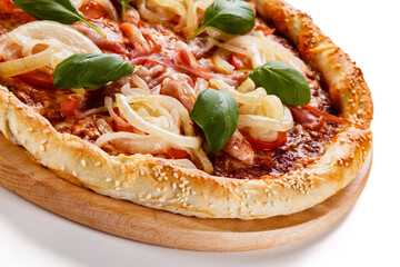 Pizza with ham, mozzarella, champignon, tomatoes and onion on white background
