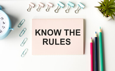 Know The Rules text written on a notebook with pencils