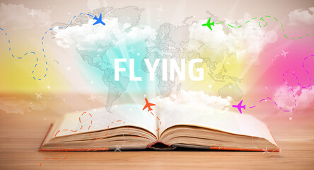 Open book with FLYING inscription, vacation concept