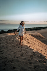 moroccan girl in the dunes of the south of spain and beach coast white tarifa bolonia