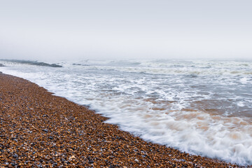 Ocean waves on a pebble beach. 