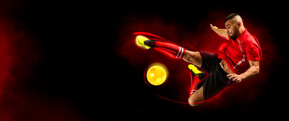 Soccer player in action on dark smoke background. Sports banner